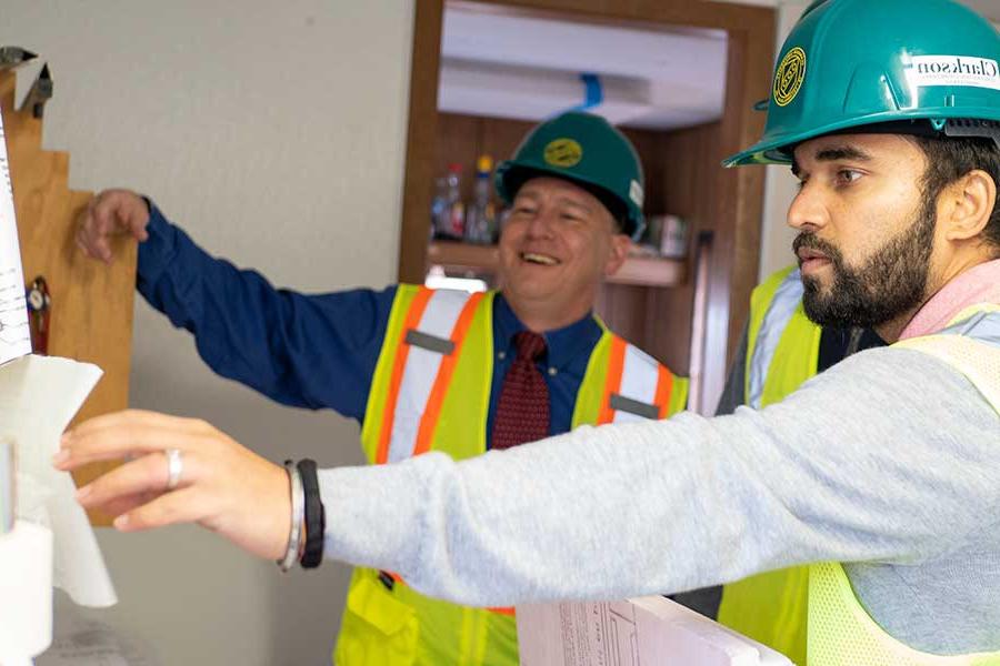 Student working with Professor Backus on a construction project