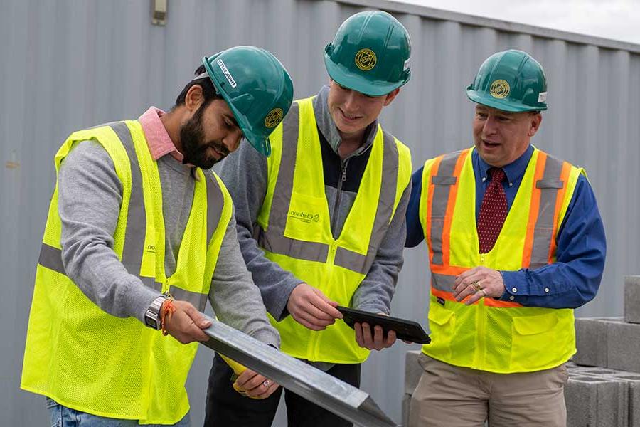 Students working with Professor Backus on a construction project